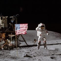 Visual of astronaut on the moon with space mobile and American flag