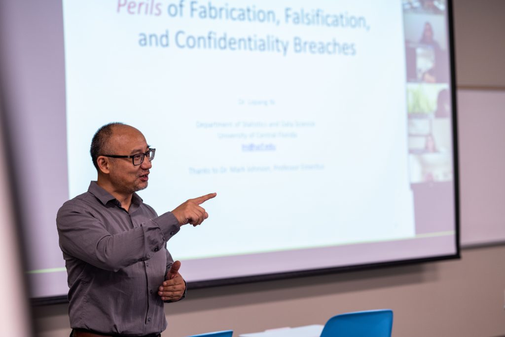 Professor teaching in front of screen in the Graduate Student Center