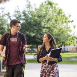 Male and female student walking on UCF campus