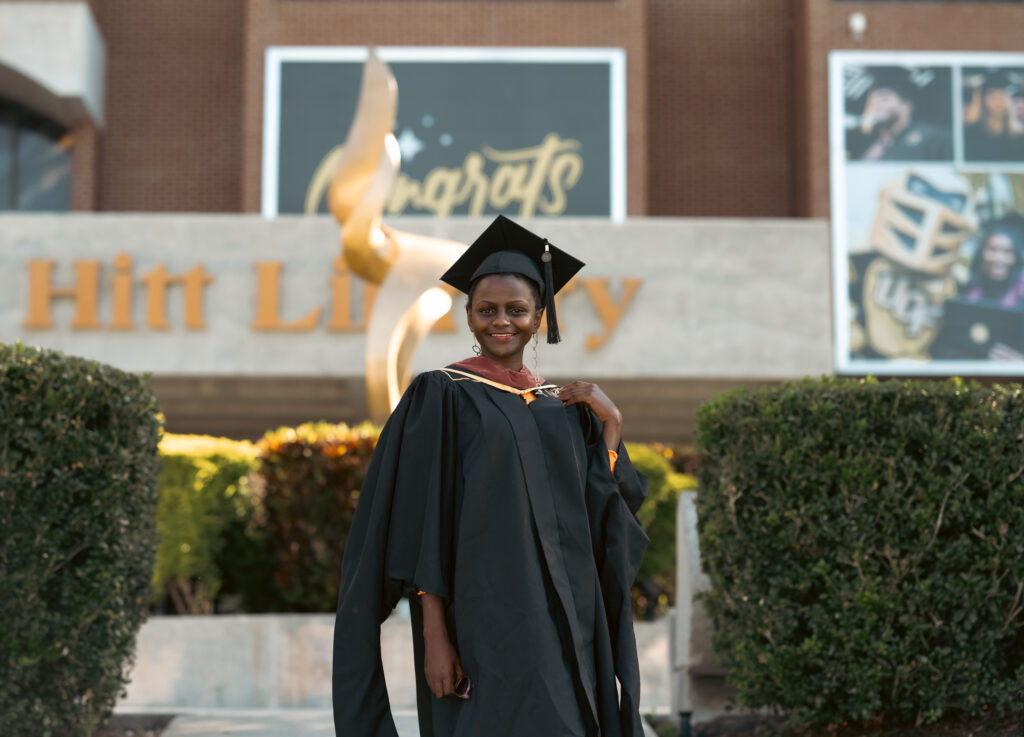 Njeri Kinuthia wearing graduation regalia and smiling