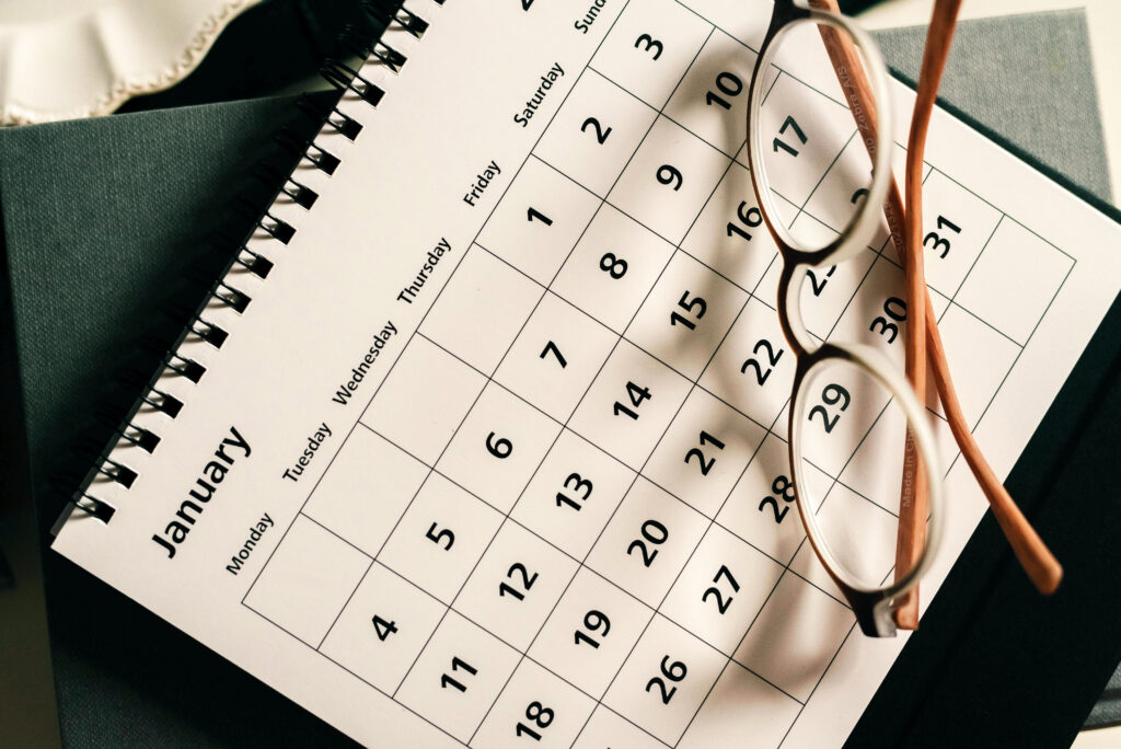 Calendar with a pair of glasses sitting on top