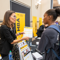 MBA representative talking to student at Grad Fair