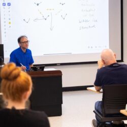 Yan Hernandez teaching physics to a class