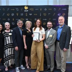 Representatives from LIfe at UCF and Student Research Week planners accepting a Founders Day plaque for establishing the first endowment for student research week.